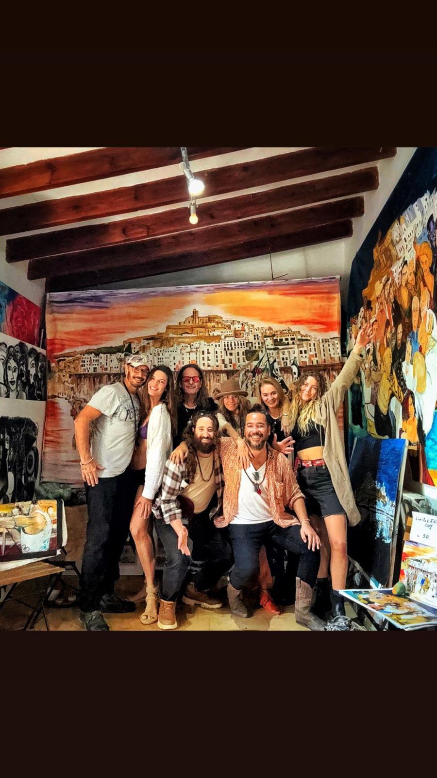 A group in the studio beneath the sunset Dalt Vila canvas