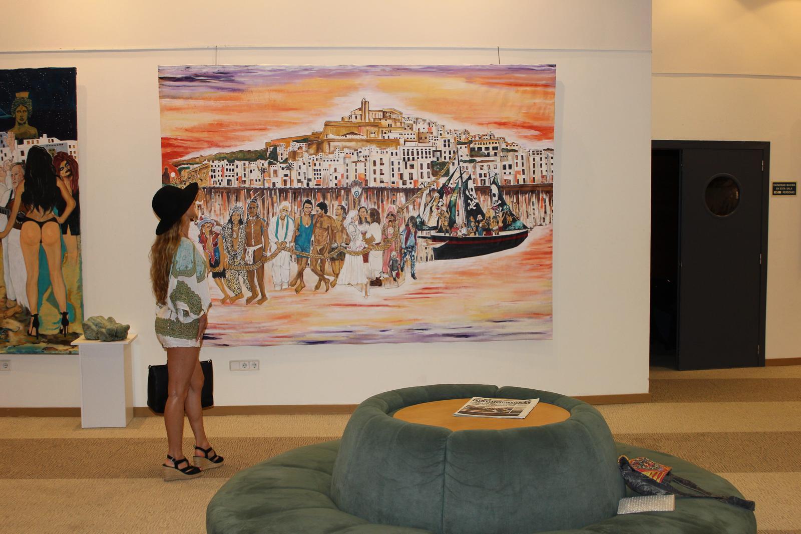 Hippies hung in the gallery, a visitor looking up at it
